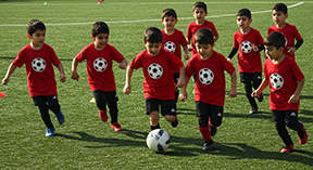 elementary boys playing soccer in their new custom DTF Tshirts
